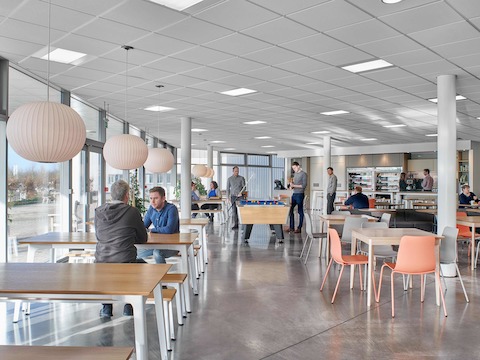 A café setting furnished with café tables, benches and side chairs.