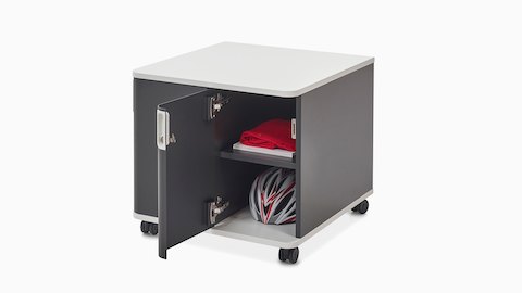 A bicycle helmet and red fabric fill an open Atlas Storage unit, viewed at an angle.