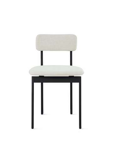 A Betwixt Chair with light grey fabric and a black frame.