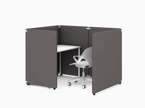 Four dark grey Bound Freestanding Screens in a booth application around a white OE1 Rectangular Table with a white Zeph Chair, viewed from an angle.