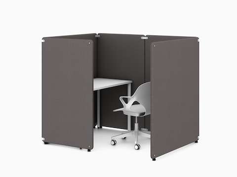 Four dark grey Bound Freestanding Screens in a booth application around a white OE1 Rectangular Table with a white Zeph Chair, viewed from an angle.