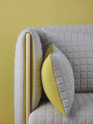 Close view of the arm detail on a light gray ColourForm sofa.