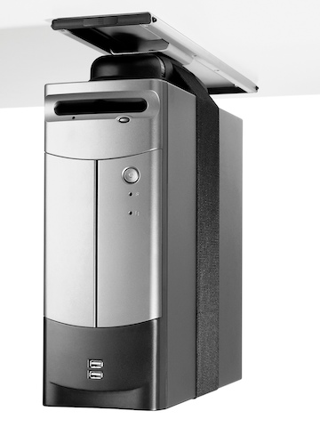 A silver CPU secured by a nylon strap and attached to the underside of a work surface with a Loop CPU Support.