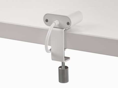 White Ello Mini USB-C power access module that is attached to a white surface.