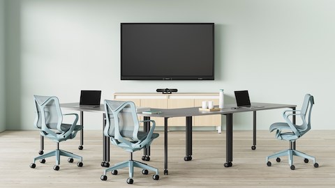 A video conference space, with grey Everywhere Tables and three glacier Cosm Chairs.