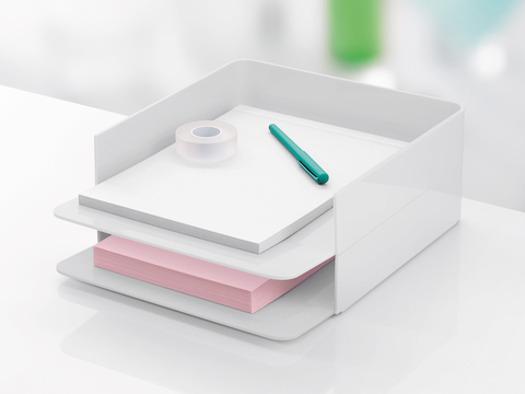 Two white Formwork Paper Trays stacked one on top of the other and containing paper, tape, and a pen.