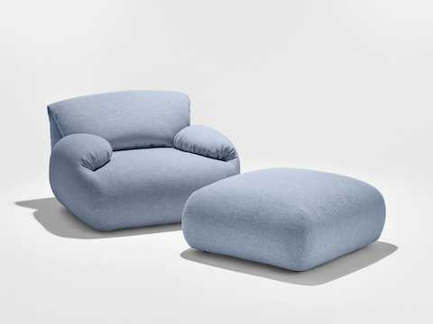 A Luva armchair and ottoman in Mode fabric.