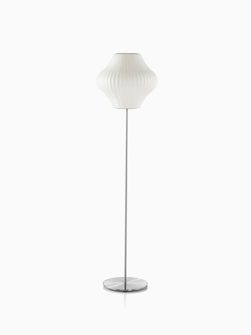 A white Nelson Pear Lotus Floor Lamp with a steel base and the smaller of two available shades.