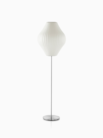 A white Nelson Pear Lotus Floor Lamp with a steel base and the larger of two available shades.