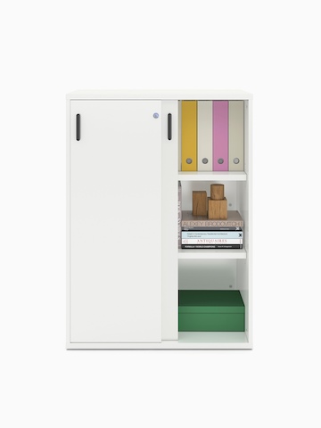 Books and binders fill a partially open Paragraph Storage unit with three modules and sliding doors, viewed from the front.