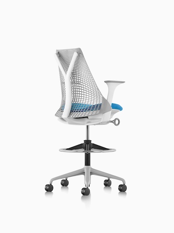 Three-quarter rear view of a light gray Sayl Stool with a blue seat.