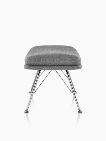 Side view of Striad Ottoman in gray upholstery with wire base. 
