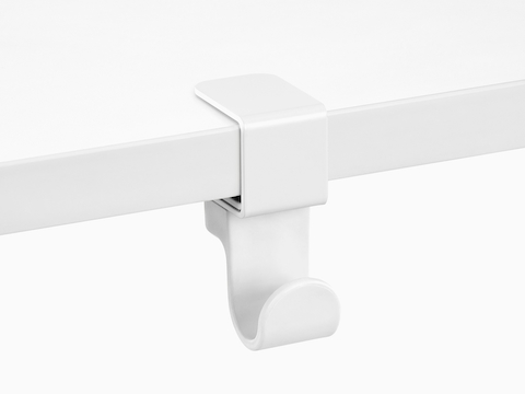 A Ubi Bag Hook clamped onto a work surface.