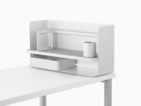 A small white Ubi desktop organiser with a bookend, pencil cup, and storage box.