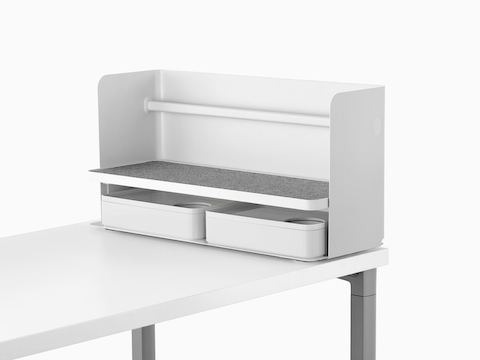 A small white Ubi desktop organiser with a grey non-skid shelf and two storage boxes.
