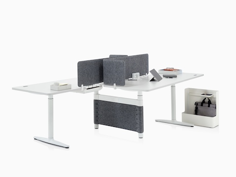 Two height-adjustable desks support various Ubi Work Tools to aid office organization, including a Ubi Mobile Bag Catch.