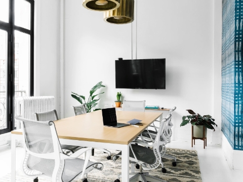 A bright conference room features natural light and Setu chairs. 