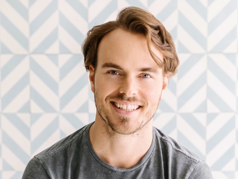 Nick Brown, CEO and founder of Soludos, smiles in his office. 