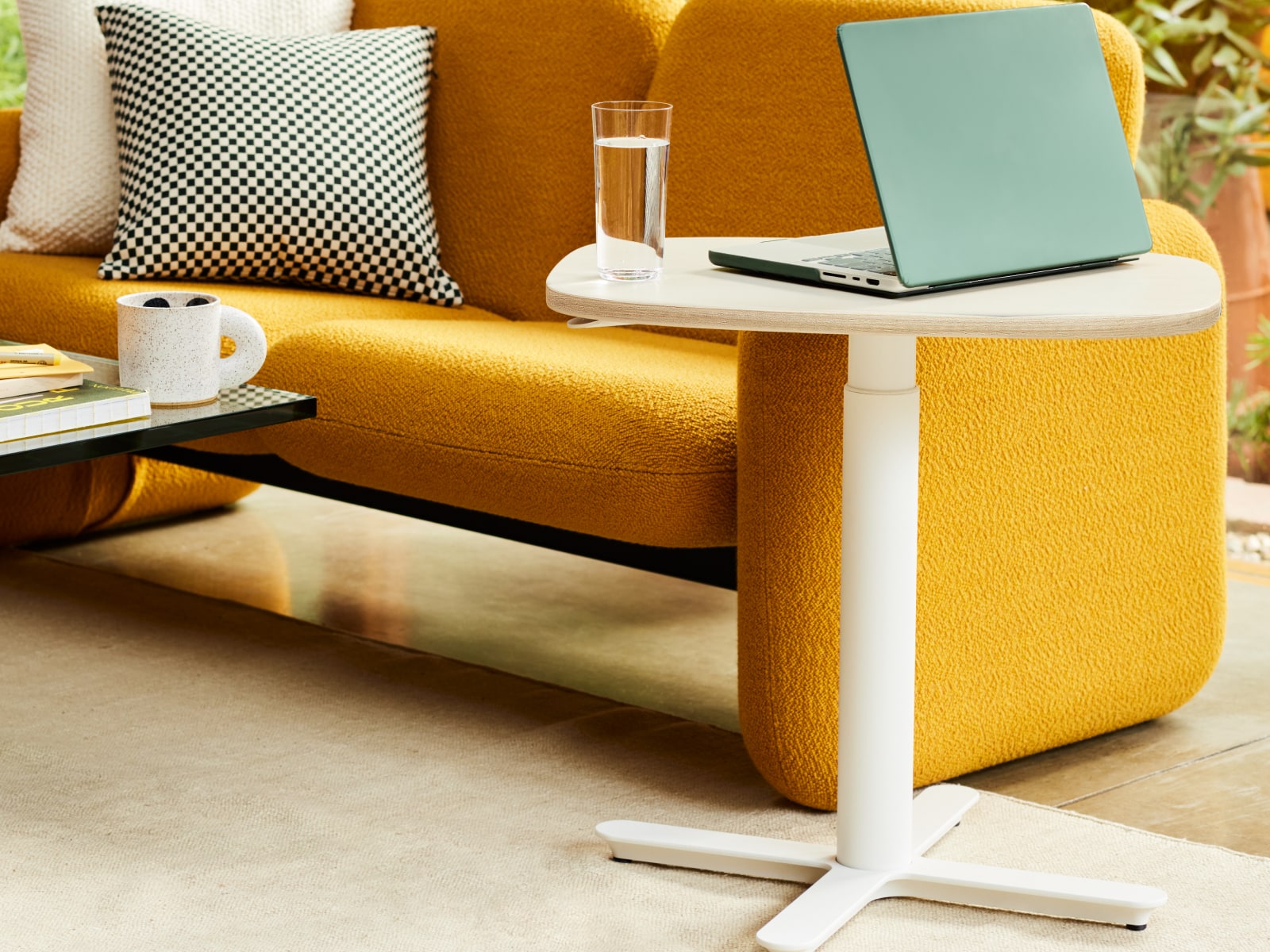 A two-seat Wilkes Modular Sofa and a small Passport Work Table.