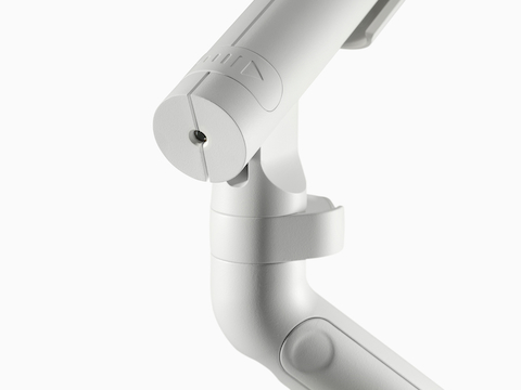 A close-up of a Flo Single monitor arm with directional indicator in white.