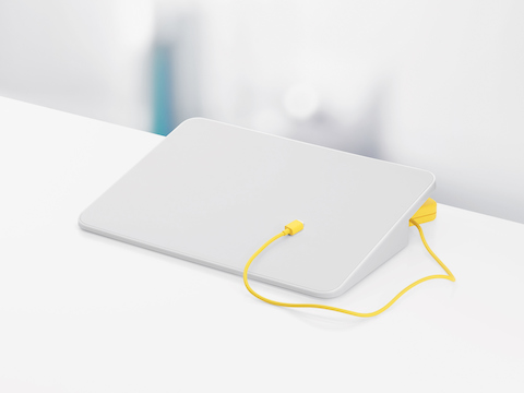 A white Formwork Media Stand and yellow charging cable.