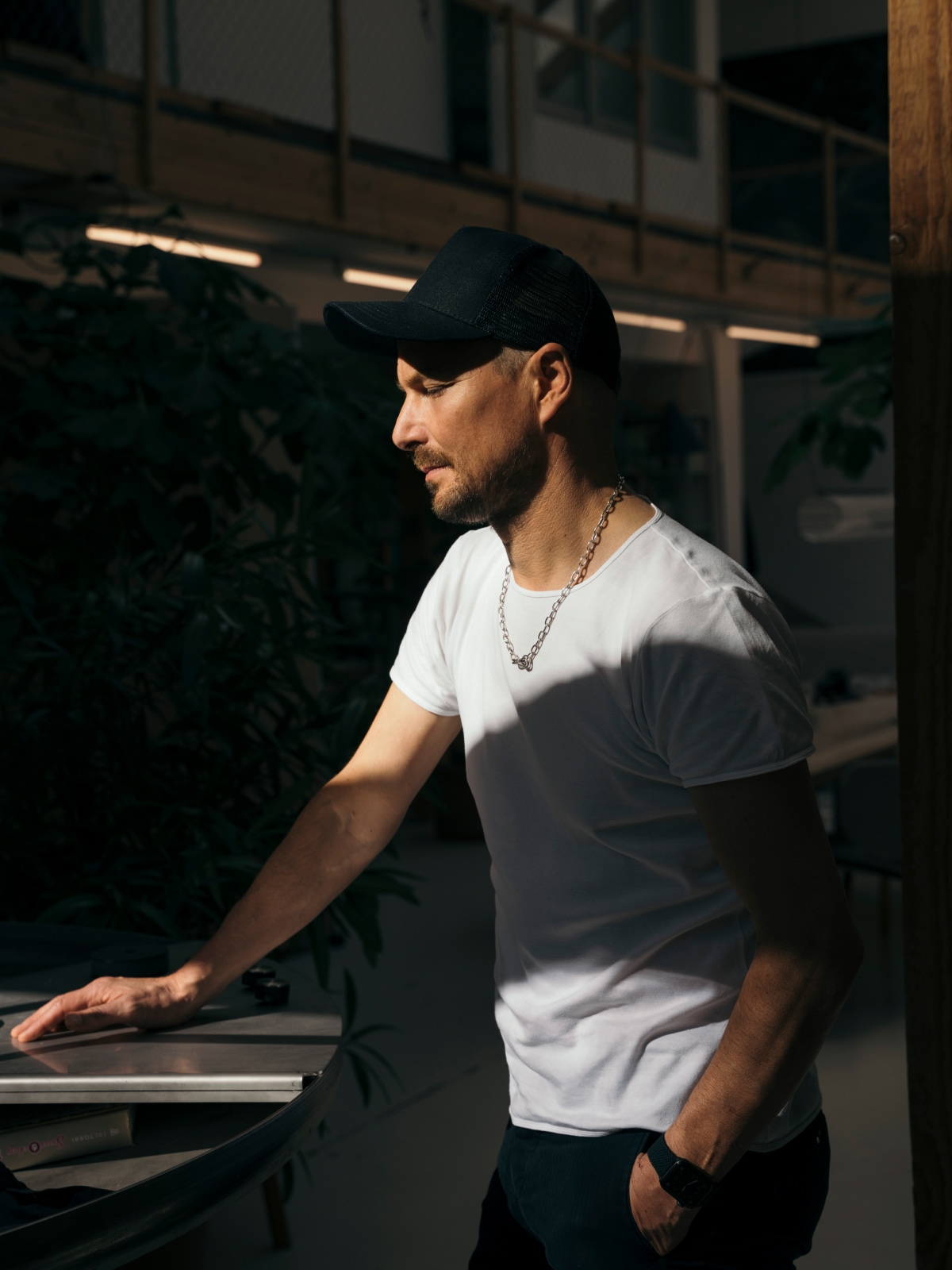 A headshot of designer Stefan Diez of Diez Office standing at a table.