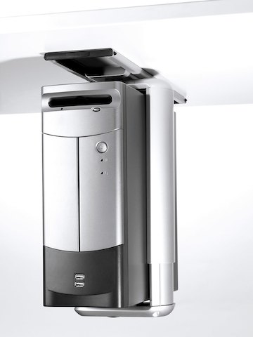 A silver CPU secured with an aluminum clamp seems to float beneath a work surface.