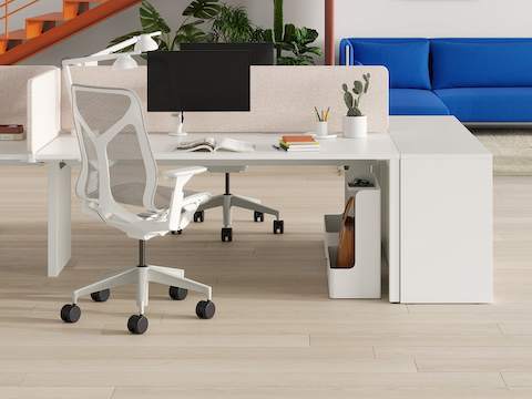 A bright Layout Studio workspace with colourful stairs ascending to the second level and additional ancillary seating in the background.