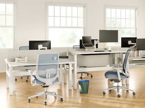 Nevi Link Sit-Stand back-to-back desk configurations in white with grey-coloured fabric screens, Lima Monitor Arms and screens, Oripura Laptop Stand and Verus Chairs.