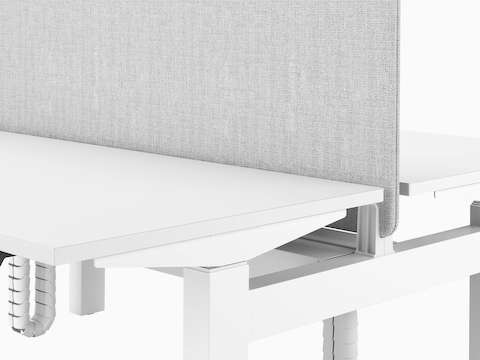 A close-up section of Nevi Link showing a back-to-back grey fabric screen mounted between two white desks.