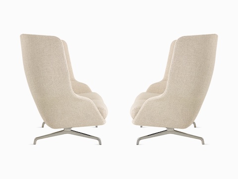 A high-back Striad Sofa in cream, side view.