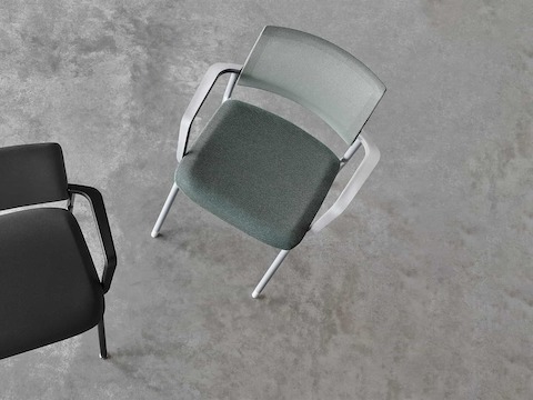 An overhead view of a black Verus Side Chair next to a green Verus Side Chair.