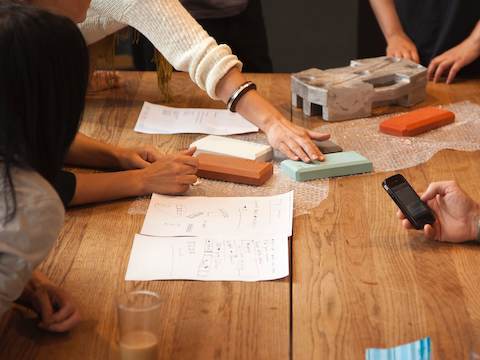 The big communal table is always in use for displaying artifacts the team is working on. Notes Carola: 