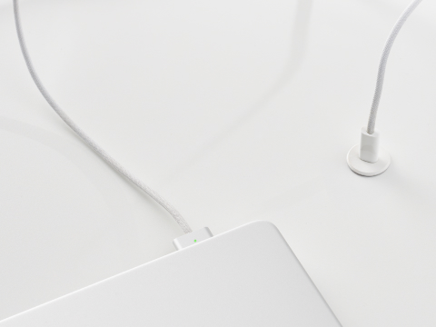 Ello Micro surface-integrated single port USB-C power solution shown in white charging a laptop.