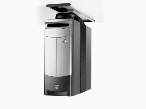 A silver CPU secured by a nylon strap and attached to the underside of a work surface with a Loop CPU Support.