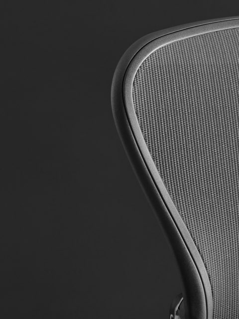 Close-up of the mesh back on a black Aeron office chair.