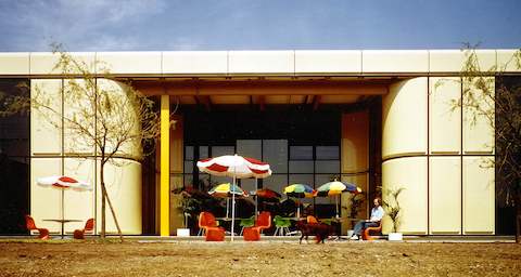 A man sits outside Herman Miller's manufacturing plant in Bath, England.
