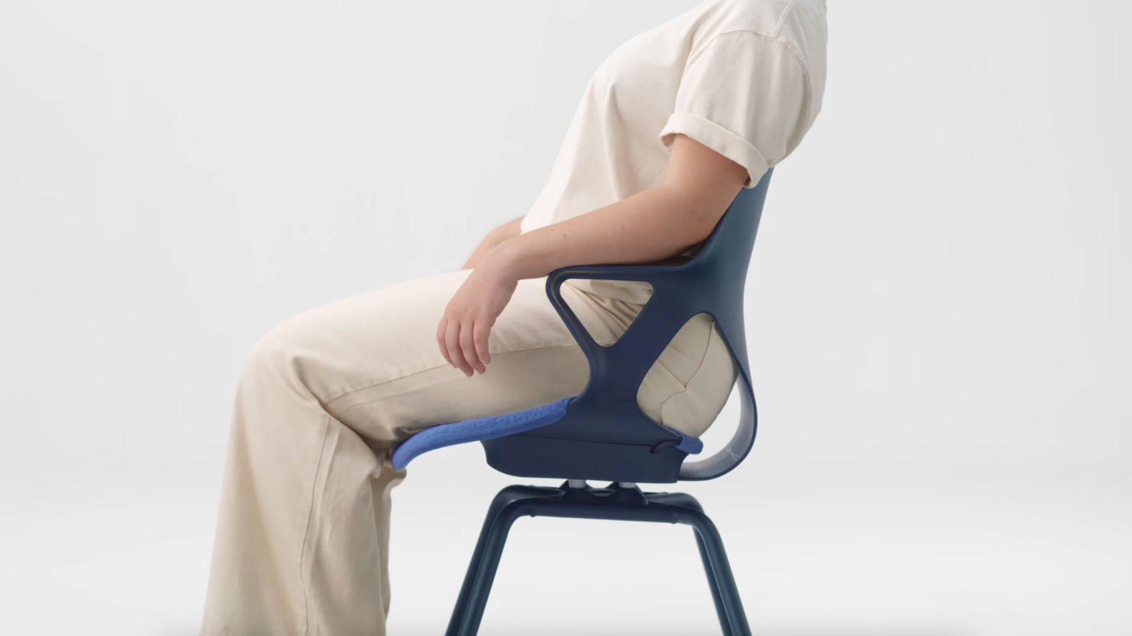 A person sitting in a Zeph Side Chair