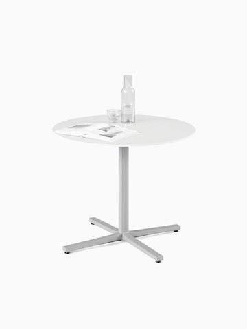 A white, round, standard height Everywhere Table with a grey column. Select to go to the Everywhere Tables product page.