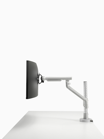 Flo Modular monitor arm in silver, viewed from the side.