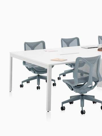 Six-person Layout Studio meeting table with grey low-back Cosm Chairs. Select to go to the Layout Studio product page.
