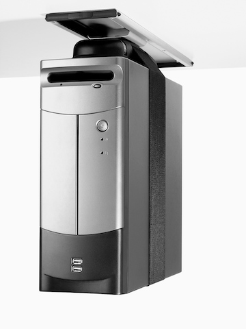 A CPU secured by a strap and attached to the underside of a work surface.