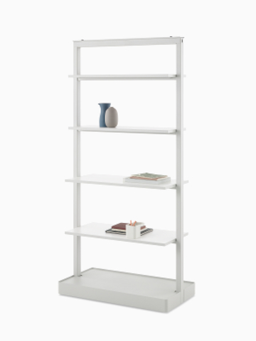 A gray OE1 Agile Wall with full shelves and styling elements, viewed from an angle.