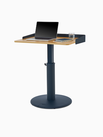 OE1 Sit-to-Stand Table with green base and white surface with green wrap screen at a standing height, viewed from a front angle.