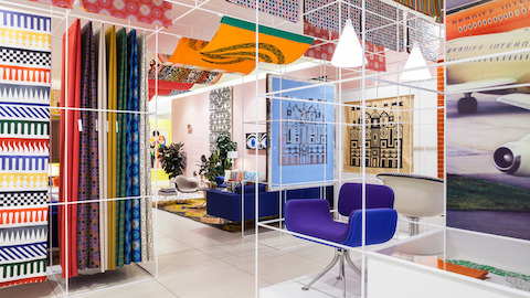 Colourful textiles designed by Alexander Girard hang in a temporay installation in New York City. Select to go to an article about Girard.