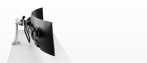 Silver triple Flo X monitor arm set up, viewed from the side.