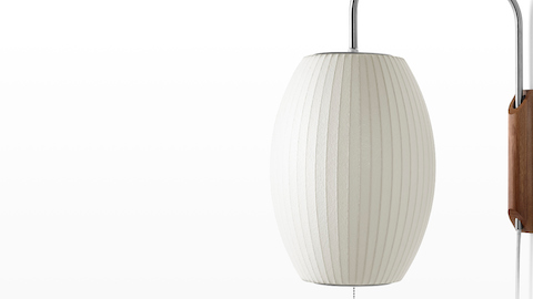 Close view of a Nelson Cigar Wall Sconce with a swivel arm and walnut wall mount.