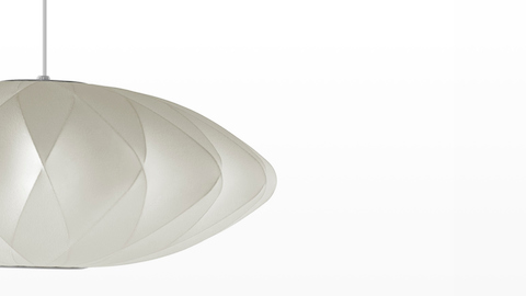 Close up of the shade of a Nelson Saucer CrissCross Bubble Pendant lamp.