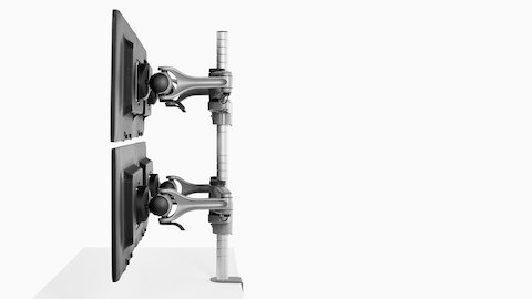 Profile view of four monitors attached to a single Wishbone Monitor Arm post.
